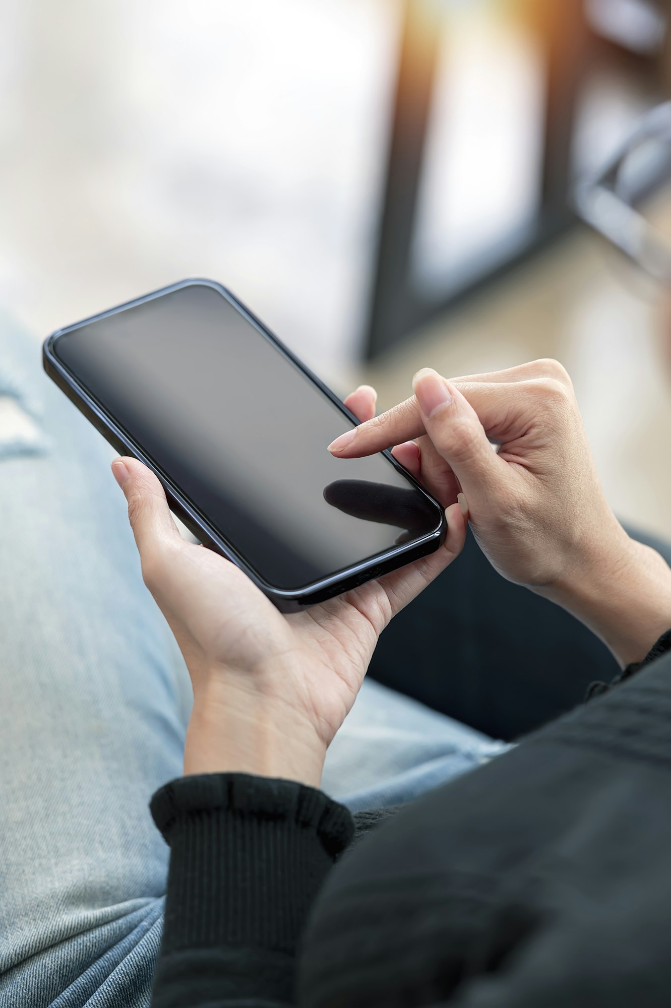 Closeup young woman using smartphone. Woman hand touch screen smartphone in hand, online message.