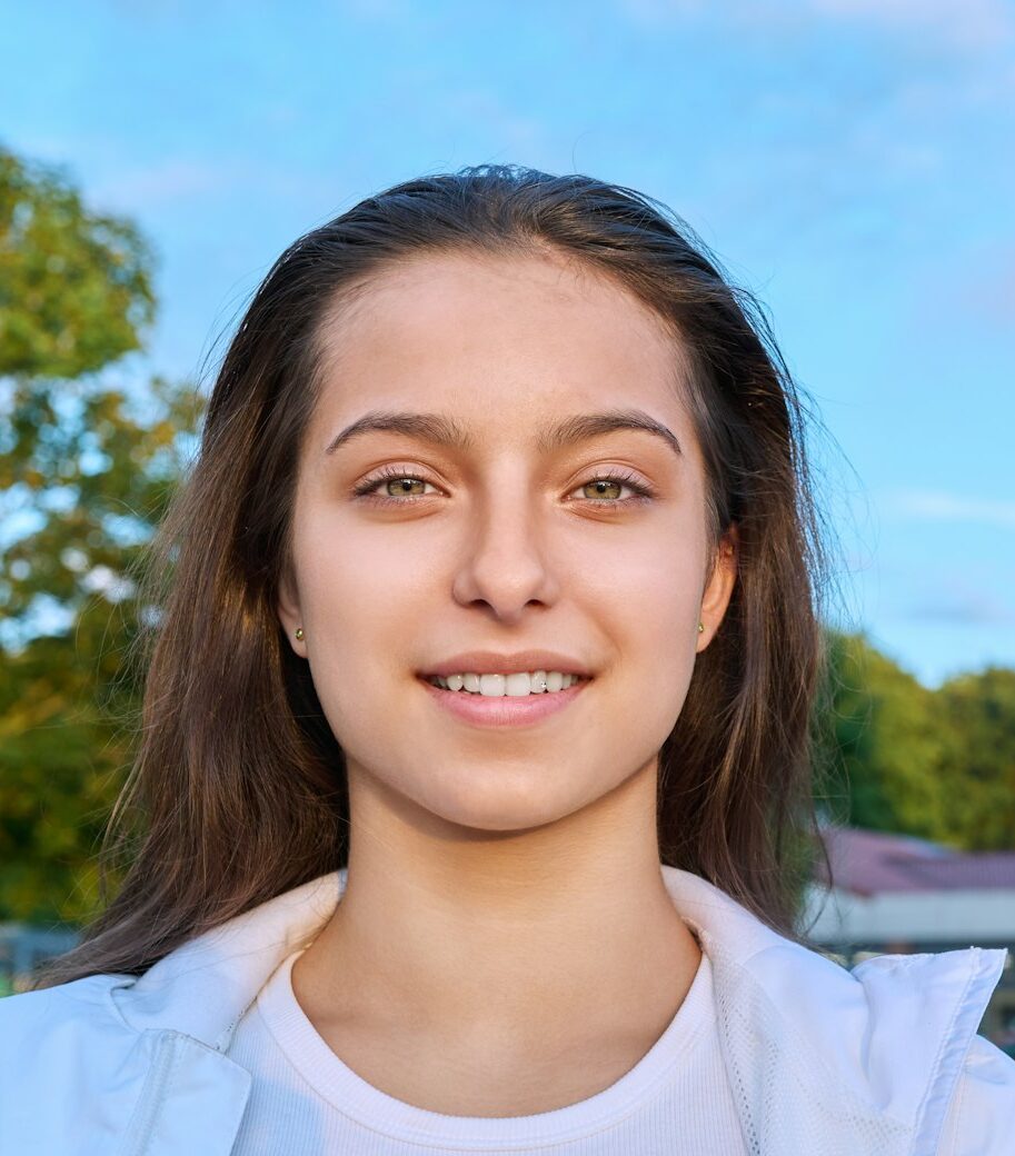 Outdoor portrait smiling girl 16, 17 year old